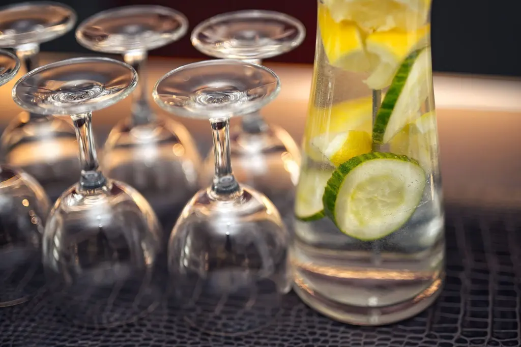 Glasses and fresh water with cucumber and lemon